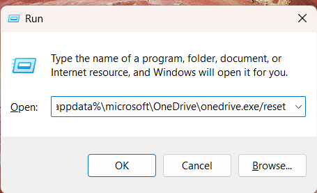 Windows Run dialog with the OneDrive reset command entered in the Open field.